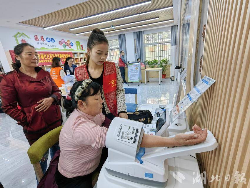 云梦县城关镇幸福社区志愿者帮老人们测量血压。通讯员聂杰杰