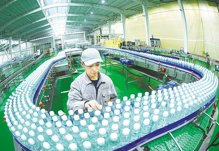 丹江口市武当山水饮料有限公司员工在加紧生产。 （湖北日报全媒记者 田悦 通讯员 顾珊 张斌 摄）