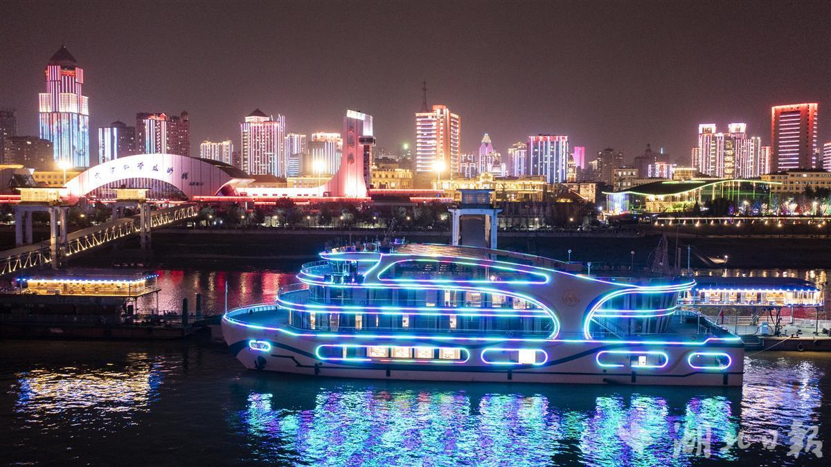 3月1日晚,停泊在武汉关码头的"长江荣耀号"游轮与两江三岸夜景交相